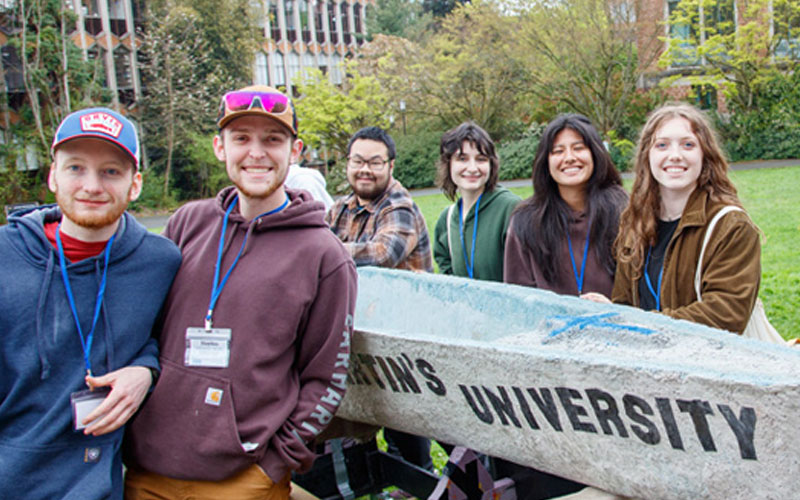 Students from the Concrete Canoe student organization pose with their concrete canoe