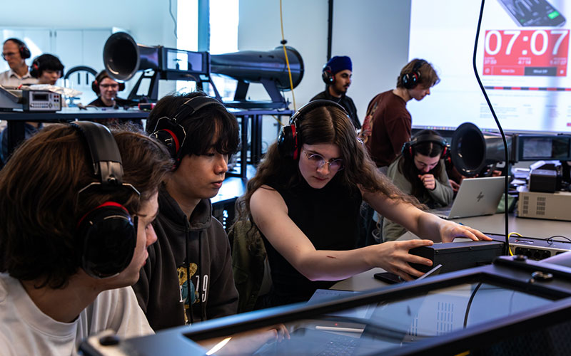 Student operates advanced laboratory equipment in a research lab, demonstrating how investments in specialized tools support hands-on learning and discovery.