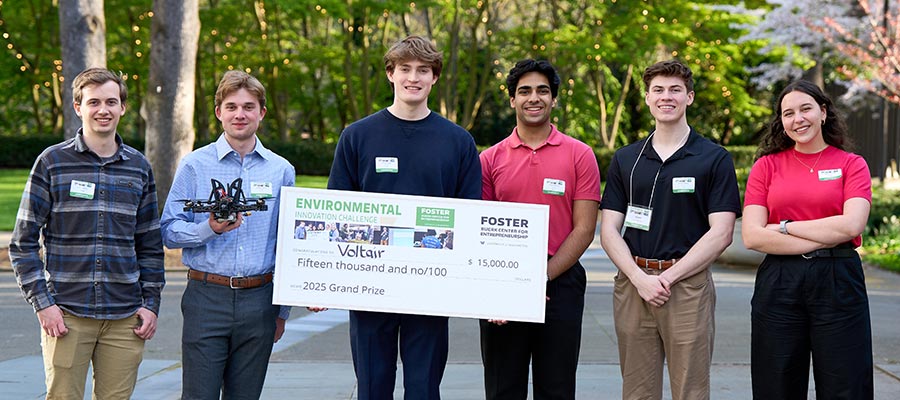 Team behind Voltair smiling while holding winning check for $15,000