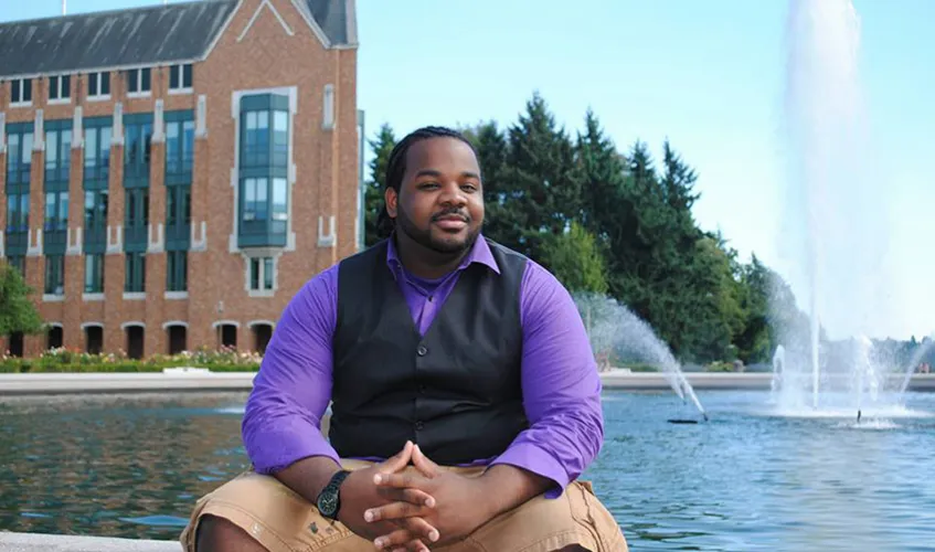 Student sitting by fountain
