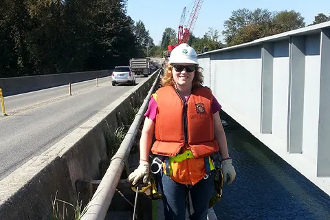 Alumna Amy Leland standing on the former Snohomish River bridge