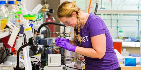Researcher wearing gloves working in lab