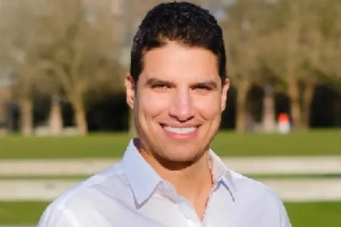 Mo Malakoutian smiling at the camera
