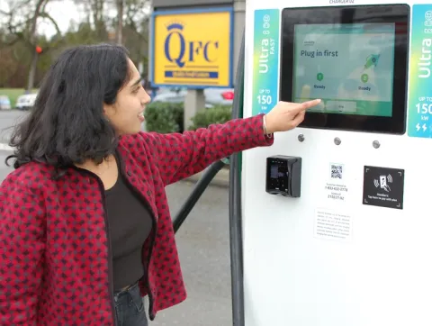 A person operating a charging station