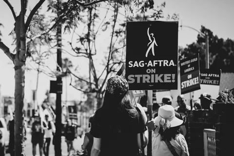 People picket on a sidewalk
