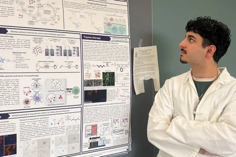 Omeed Yazdani glancing over at research