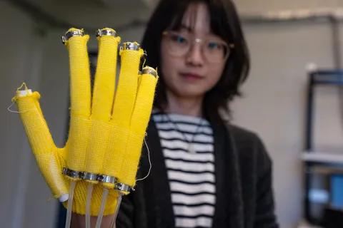 A digitally machine-knitted assistive glove