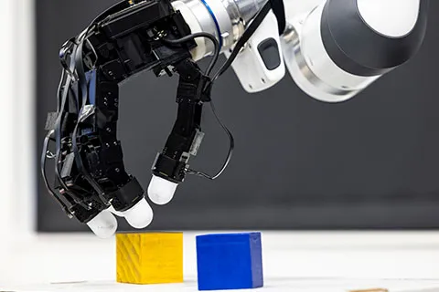Robot arm about to grip small cubes