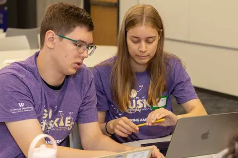 Two engineering students are working on an assignment together