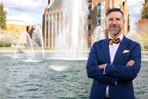 Noah A. Smith poses in front of the Drumheller Fountain at the University of Washington.