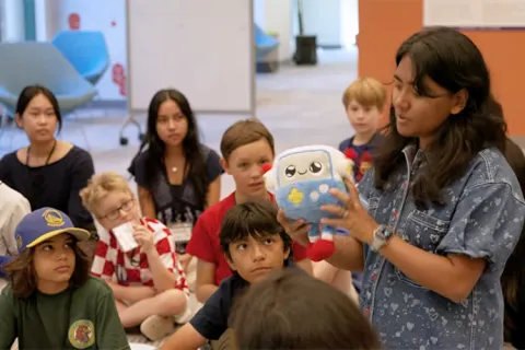 Aayushi Dangol speaking with children