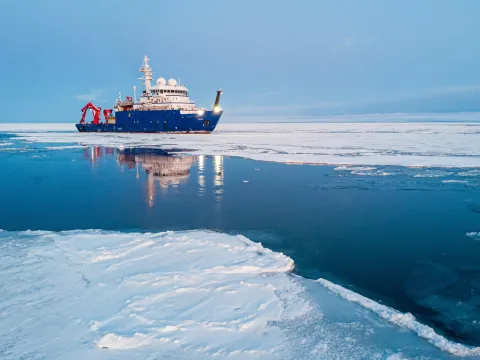 A ship breaking a path through sea ice