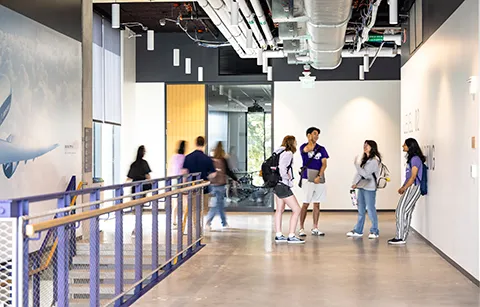 Students standing in an IEB hallway