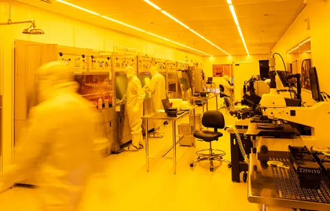 Researchers in full-body clean suits working within the WNF