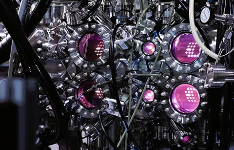 Complex machine with multiple magenta-hued lights pointing in different directions