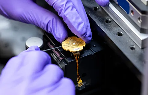 Researcher working on a device