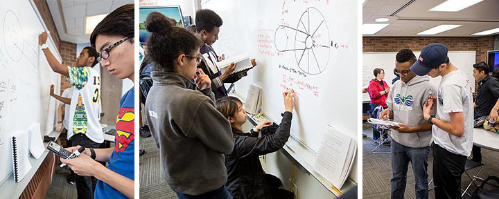 Students working on the whiteboards in the engineering academic center. 