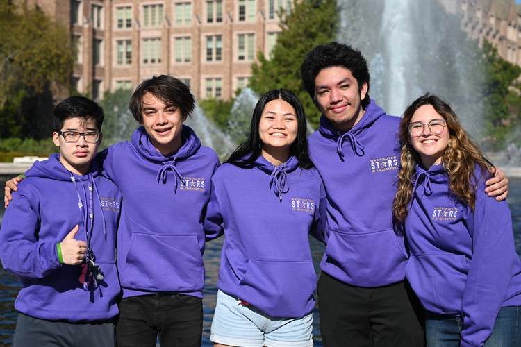 Group shot of engineering students standing by fountain