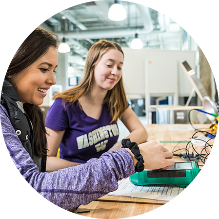 two students looking at an electronic device