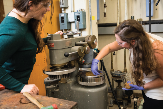 women in a lab working on a machine