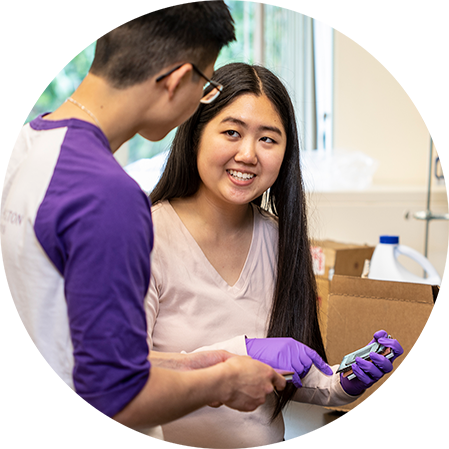 Two students speaking with each other in a lab