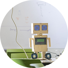a paper robot model on a desk
