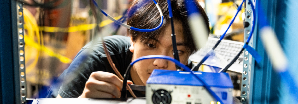 Man adjusting cables in a lab