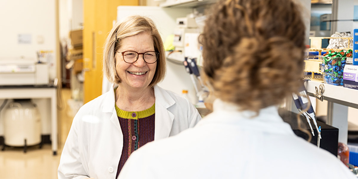 Professor Lidstrom talking to student at her lab