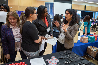 Students chatting with employers at WiSE Conference Career Resource Fair