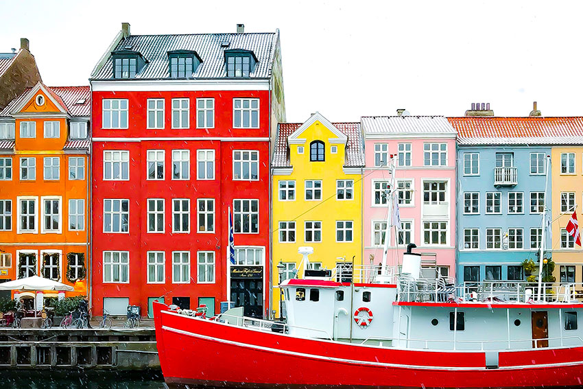 A boat on a river in front of colorful houses