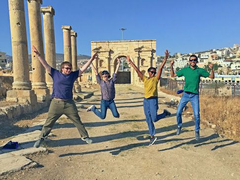 Students jumping in front of landmark