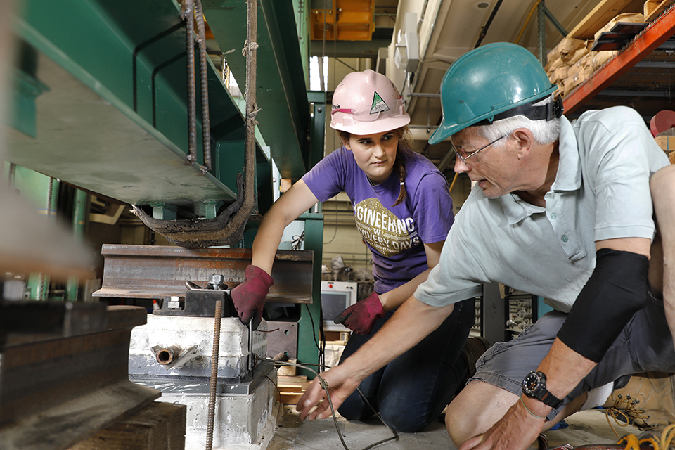 a woman and a man in a machine shop