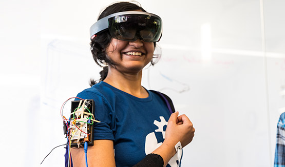 Student smiling while trying on wearable prototype