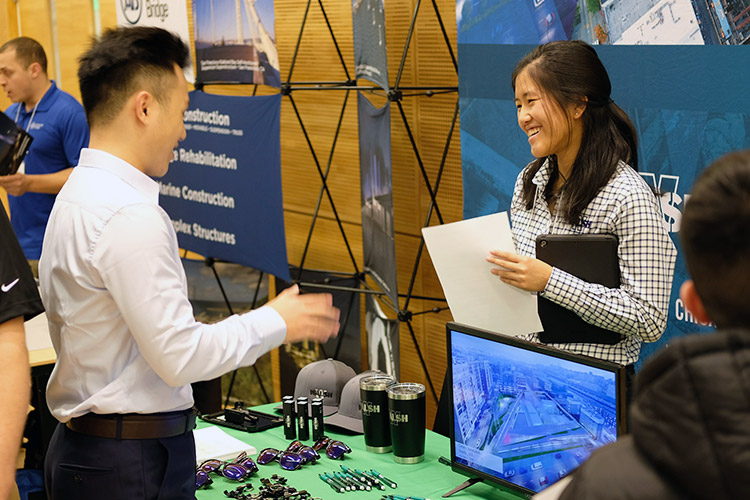 Two people talking to each other during a job fair