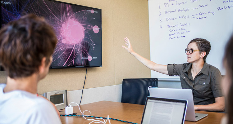 Professor Starbird working with students in lab