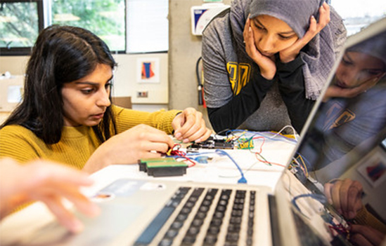 two students analyzing a circuit