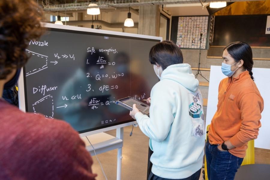 Student writing on a whiteboard