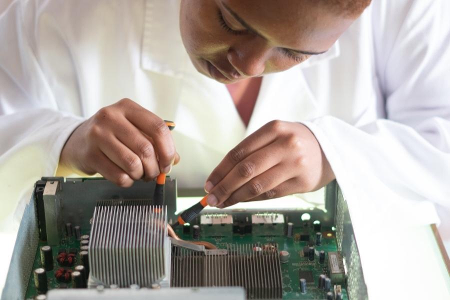 Woman fixing a computer