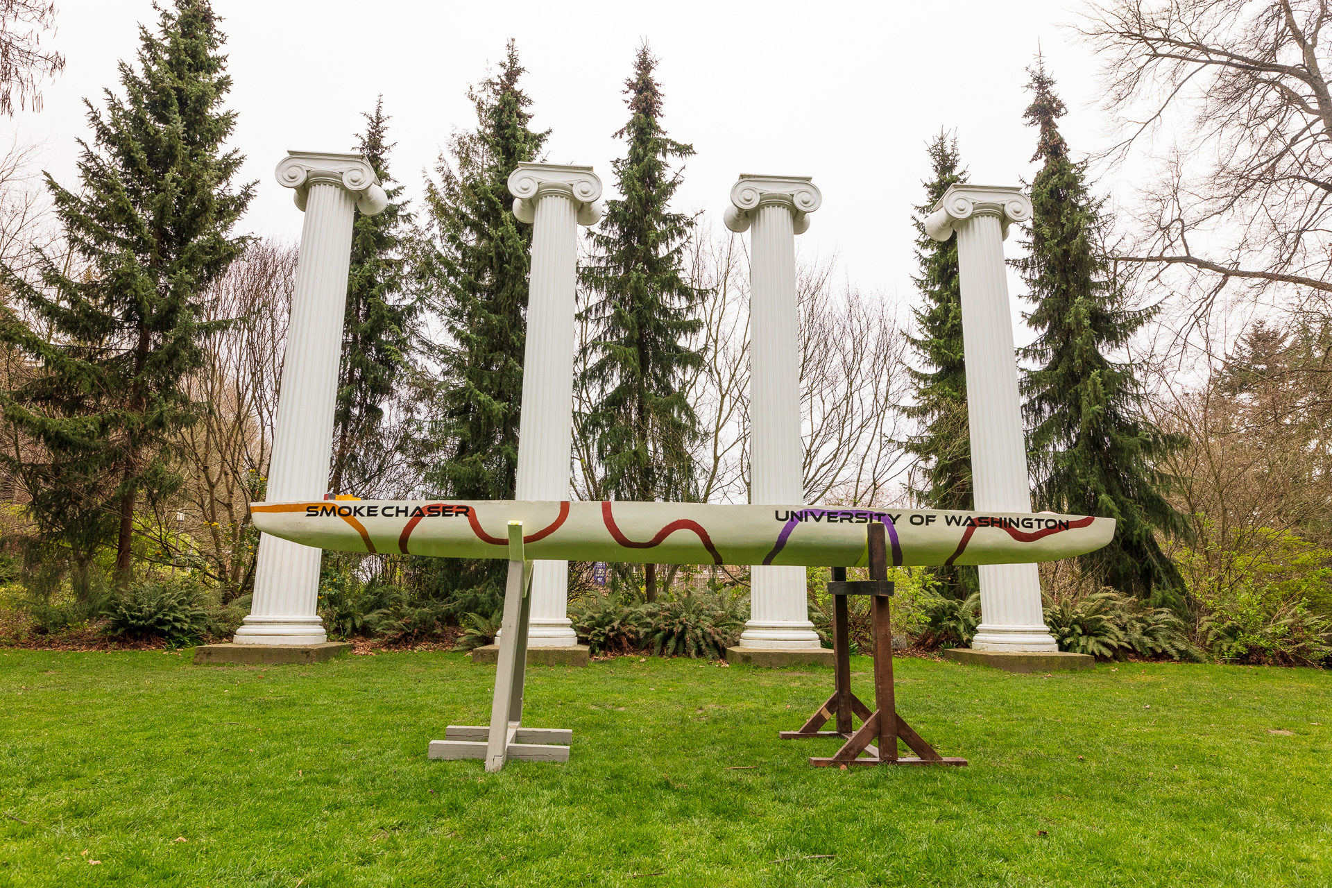 A canoe is on display in a grassy area