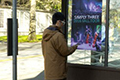 person looking at poster
