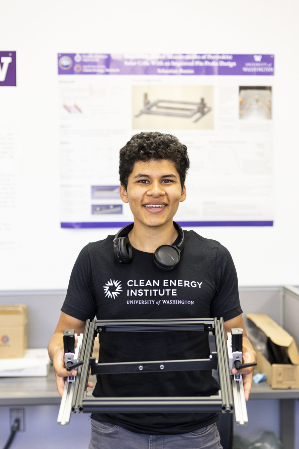 Man holding a device and smiling at the camera