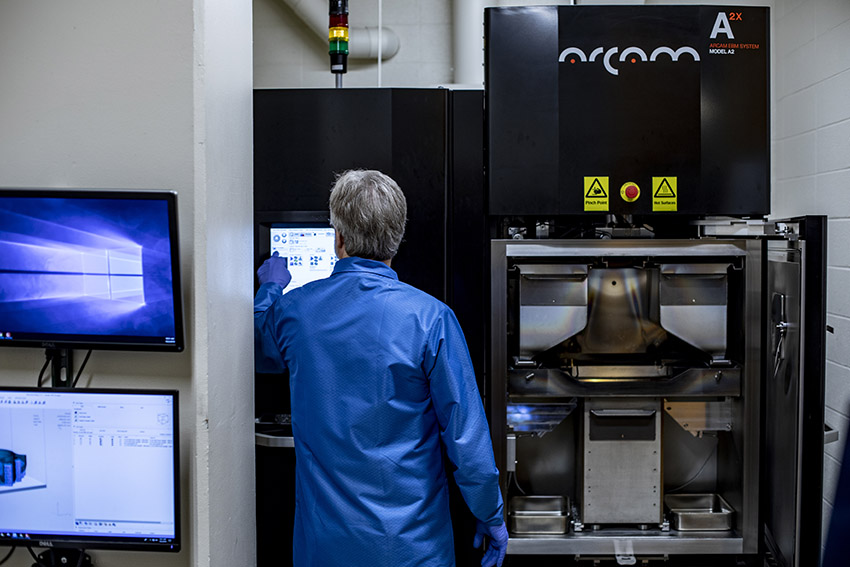 Bill Kuykendall adjusting the controls of the printer