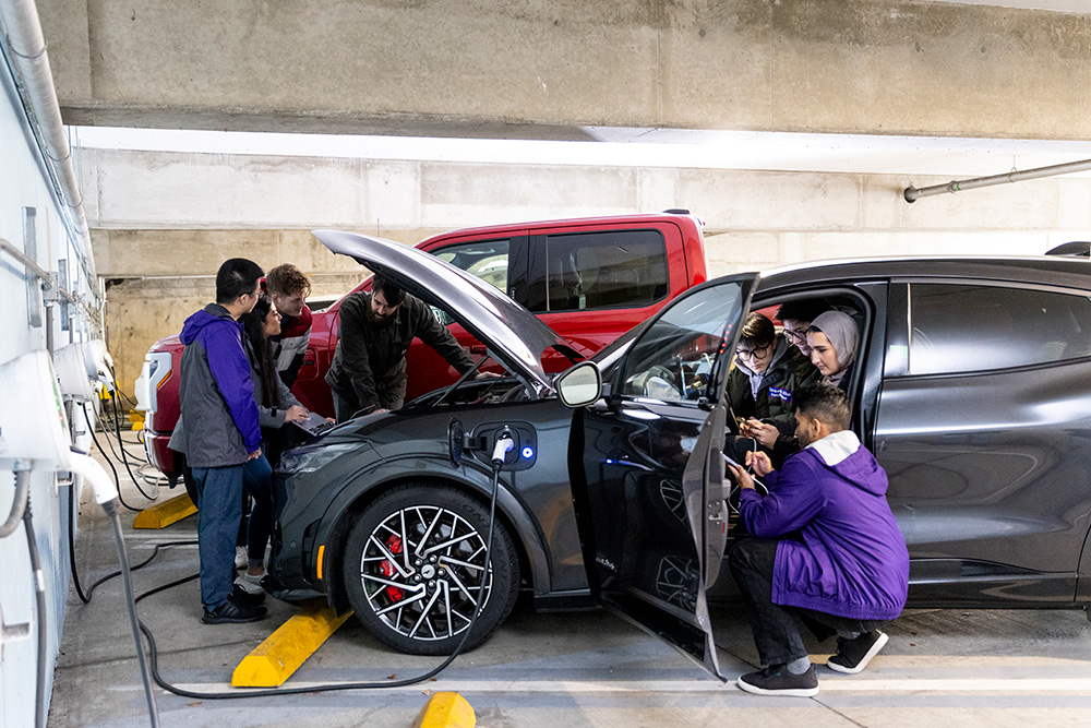 students working on an electric vehicle