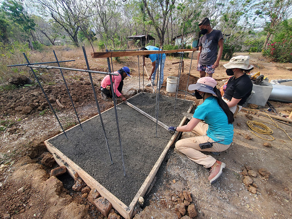 EWB members and community members work on the foundation for a compostable latrine