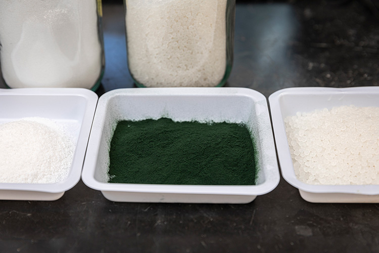 White bins containing white and green powder