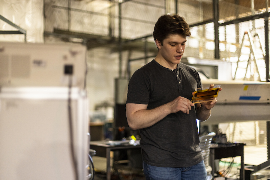 A person in a lab holding a device