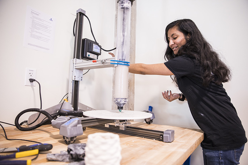 a student with the Potterbot Ceramic 3D printer