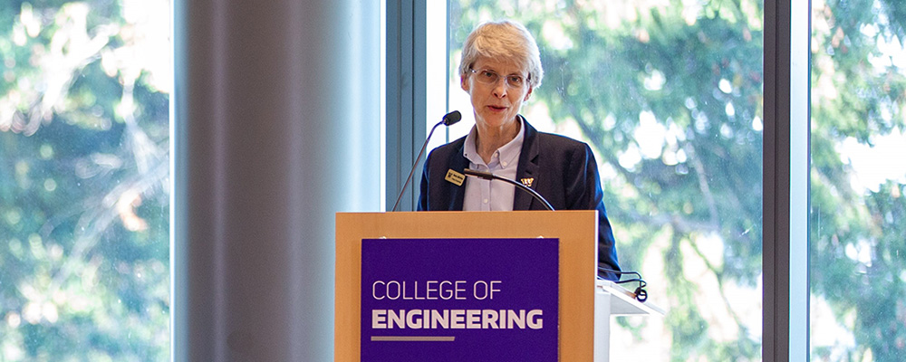 Nancy Allbritton giving a speech at a podium