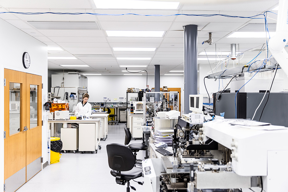 Inside of a lab full of equipment with a researcher working in a corner