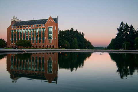 A picture of a brick building and a fountain on a university campus